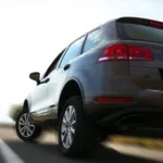 Grey SUV driving on an open road